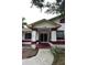 Inviting front entrance with covered porch, decorative columns, and well-maintained landscaping at 11364 Orangewood Ct, Spring Hill, FL 34609