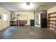 Well-lit garage with storage shelves, providing organized space for vehicles and belongings at 11364 Orangewood Ct, Spring Hill, FL 34609