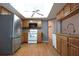 Traditional kitchen featuring wood cabinets, stainless steel refrigerator and open lighting at 11364 Orangewood Ct, Spring Hill, FL 34609