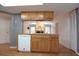 Galley kitchen with oak cabinetry and pass-through to the adjacent living area at 11364 Orangewood Ct, Spring Hill, FL 34609