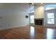 Bright living room featuring a fireplace, vaulted ceilings, and natural light from large windows at 11364 Orangewood Ct, Spring Hill, FL 34609