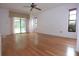 Large living room featuring hardwood floors, neutral walls, and large glass sliding doors to the outside at 11364 Orangewood Ct, Spring Hill, FL 34609