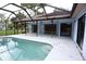 Backyard pool with screened-in patio, perfect for outdoor entertaining and relaxation at 11364 Orangewood Ct, Spring Hill, FL 34609