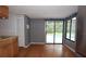 Sunroom with wood floors overlooking a pool through sliding glass doors at 11364 Orangewood Ct, Spring Hill, FL 34609