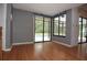 Sunroom with wood floors and sliding glass doors leading to a screened pool area at 11364 Orangewood Ct, Spring Hill, FL 34609