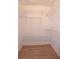 Bright walk-in closet with white walls and metal shelving for optimized storage space at 11364 Orangewood Ct, Spring Hill, FL 34609