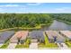 Aerial view of a row of homes backing onto a lake with lush green surroundings at 11579 Weaver Hollow Rd, New Port Richey, FL 34654