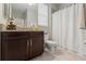 Bathroom featuring a single vanity with granite countertop, a toilet, and a shower with a curtain at 11579 Weaver Hollow Rd, New Port Richey, FL 34654