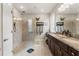Elegant bathroom featuring a double vanity, granite countertops, and a spacious walk-in shower at 11579 Weaver Hollow Rd, New Port Richey, FL 34654