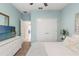 Bright bedroom features a TV, a double door closet, and light blue walls at 11579 Weaver Hollow Rd, New Port Richey, FL 34654