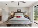Inviting bedroom featuring a tufted headboard, stylish lamps, and a cozy sitting area at 11579 Weaver Hollow Rd, New Port Richey, FL 34654