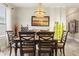 Elegant dining room featuring a chandelier, dining table with seating, and stylish decor at 11579 Weaver Hollow Rd, New Port Richey, FL 34654