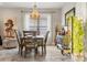 Dining area with modern chandelier, adjacent to a comfortable seating area at 11579 Weaver Hollow Rd, New Port Richey, FL 34654