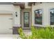 Charming home exterior featuring a decorative front door and stone accents at 11579 Weaver Hollow Rd, New Port Richey, FL 34654