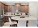 Open concept kitchen with dark cabinets, stainless steel appliances and center island with white counter seating at 11579 Weaver Hollow Rd, New Port Richey, FL 34654