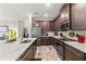 Spacious kitchen featuring dark wood cabinets and marble countertops at 11579 Weaver Hollow Rd, New Port Richey, FL 34654