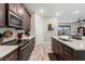 Modern kitchen with dark cabinetry, stainless appliances, and island sink at 11579 Weaver Hollow Rd, New Port Richey, FL 34654