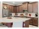 Kitchen with dark wood cabinets, white countertops, stainless steel appliances, and a center island with seating at 11579 Weaver Hollow Rd, New Port Richey, FL 34654