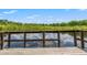Picturesque view of the lake from the wooden deck with a tranquil and serene ambiance at 11579 Weaver Hollow Rd, New Port Richey, FL 34654