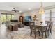 Open-concept living room and dining area, featuring wood-look tile floors at 11579 Weaver Hollow Rd, New Port Richey, FL 34654