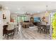 Open living space featuring a living room and dining area, perfect for modern living and entertaining guests at 11579 Weaver Hollow Rd, New Port Richey, FL 34654