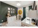 Stylish office area with dark green accent wall, desk, storage, and modern decor at 11579 Weaver Hollow Rd, New Port Richey, FL 34654