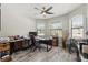 Bright home office with wood-look floors, large windows, ceiling fan, and outside views at 11579 Weaver Hollow Rd, New Port Richey, FL 34654