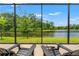 Relax on the patio and enjoy the serene lake views and lush greenery in a private setting at 11579 Weaver Hollow Rd, New Port Richey, FL 34654