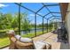Cozy seating on screened patio offers serene water views and a tranquil outdoor experience at 11579 Weaver Hollow Rd, New Port Richey, FL 34654