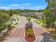 Gated community entrance with manicured landscaping and well-maintained neighborhood street at 11579 Weaver Hollow Rd, New Port Richey, FL 34654