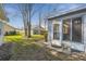 Backyard with a view of the screened-in porch, a bench, and other houses at 11637 Spindrift Loop, Hudson, FL 34667