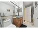 Bright bathroom featuring a wooden vanity, and a toilet near the door at 11637 Spindrift Loop, Hudson, FL 34667