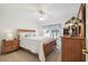 Comfortable bedroom featuring a wood bed frame and dresser, with a ceiling fan at 11637 Spindrift Loop, Hudson, FL 34667