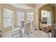 Bright breakfast nook featuring a glass table, white chairs, and multiple windows at 11637 Spindrift Loop, Hudson, FL 34667