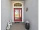 Close-up of front door featuring a decorative glass panel and sidelights at 11637 Spindrift Loop, Hudson, FL 34667