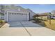 A lovely single-Gathering home with a gray exterior, landscaped yard, and attached two-car garage at 11637 Spindrift Loop, Hudson, FL 34667