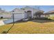 Inviting single-Gathering home with an attached garage and beautifully landscaped front yard at 11637 Spindrift Loop, Hudson, FL 34667