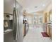 The kitchen features stainless steel appliances, lots of windows, and light tiled flooring at 11637 Spindrift Loop, Hudson, FL 34667