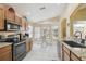 Bright kitchen with lots of windows, an adjacent dining area, and stainless steel appliances at 11637 Spindrift Loop, Hudson, FL 34667