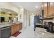 Charming kitchen featuring granite countertops, wood cabinetry, and neutral colored tile floors at 11637 Spindrift Loop, Hudson, FL 34667
