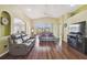 Open living room featuring hardwood floors, comfortable seating, and an entertainment center at 11637 Spindrift Loop, Hudson, FL 34667