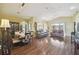 A spacious living room boasts wood floors, vaulted ceilings, and an open floor plan at 11637 Spindrift Loop, Hudson, FL 34667
