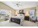 Spacious main bedroom with a ceiling fan and large windows for natural light at 11637 Spindrift Loop, Hudson, FL 34667