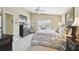 Spacious main bedroom with a ceiling fan and television at 11637 Spindrift Loop, Hudson, FL 34667