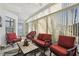 Sunroom with tile flooring, vertical blinds, comfortable seating, and a ceiling fan at 11637 Spindrift Loop, Hudson, FL 34667