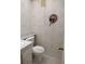 Cozy half-bathroom with patterned wallpaper and decorative fixtures at 11715 Boynton Ln # 74B, New Port Richey, FL 34654