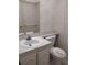 Compact half-bath features a vanity, mirror, and floral accents at 11715 Boynton Ln # 74B, New Port Richey, FL 34654