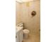 A quaint bathroom featuring patterned wallpaper, sink, and toilet creating a cozy atmosphere at 11715 Boynton Ln # 74B, New Port Richey, FL 34654