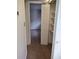 Bedroom features an open closet and view into hall at 11715 Boynton Ln # 74B, New Port Richey, FL 34654