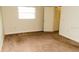 Bedroom with neutral carpets, a window and closet, creating a comfortable living space with a view of the property at 11715 Boynton Ln # 74B, New Port Richey, FL 34654